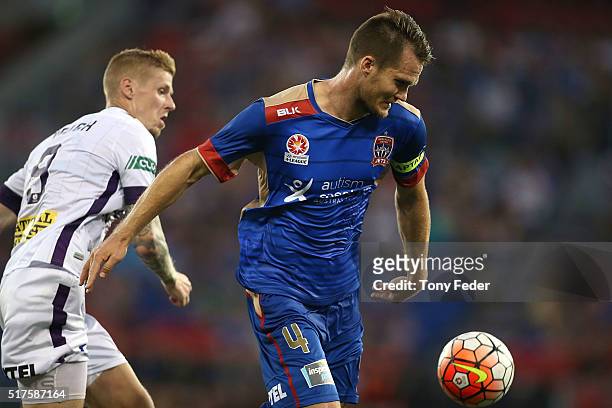 Nigel Boogaard of the Jets contests the ball with Andrew Keogh of the Glory during the round 25 A-League match between the Newcastle Jets and the...