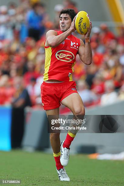 Matt Rosa of the Suns takes a mark during the round one AFL match between the Gold Coast Suns and the Essendon Bombers at Metricon Stadium on March...