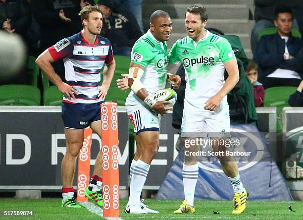 Patrick Osborne of the Highlanders is congratulated by his teammates after scoring a try during the round five Super Rugby match between the...