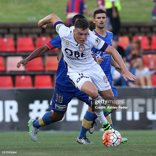 Shane Lowry of Perth Glory controls the ball ahead of the Jets defence during the round 25 A-League match between the Newcastle Jets and the Perth...