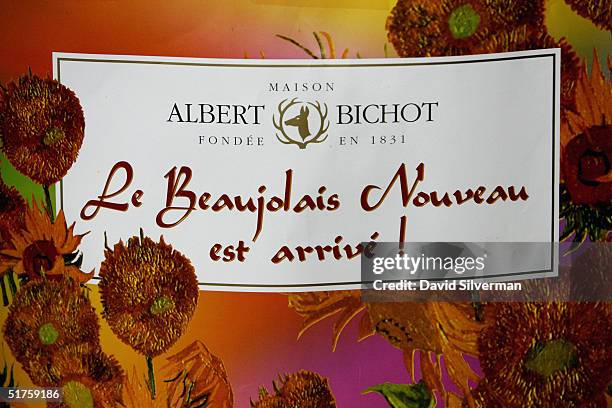 Poster heralds the arrival of French winemaker Albert Bichot's Beaujolais Nouveau 2004 at George Hinawi's liquor merchants around midnight between...