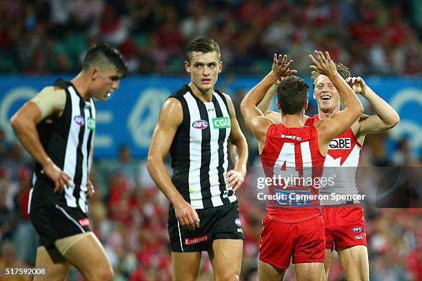 Tom Papley of the Swans celebrates with team mate Callum Mills after kicking a goal during the round one AFL match between the Sydney Swans and the...