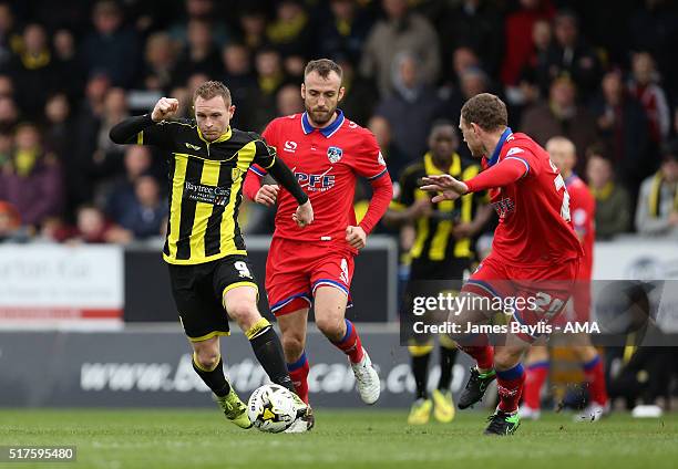 Stuart Beavon of Burton Albion and Brian Wilson of Oldham Athletic in action during the Sky Bet League One match between Burton Albion and Oldham...