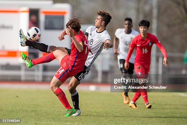 Chanhee Han of South Korea challenges Benjamin Henrichs of Germany during the international friendly match between Germany and South Korea on March...