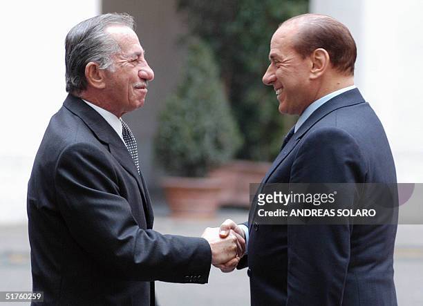 Italian Prime Minister Silvio Berlusconi greets Cyprus President Tassos Papadopoulos before their meeting at Chigi palace in Rome, 18 Novembre 2004....