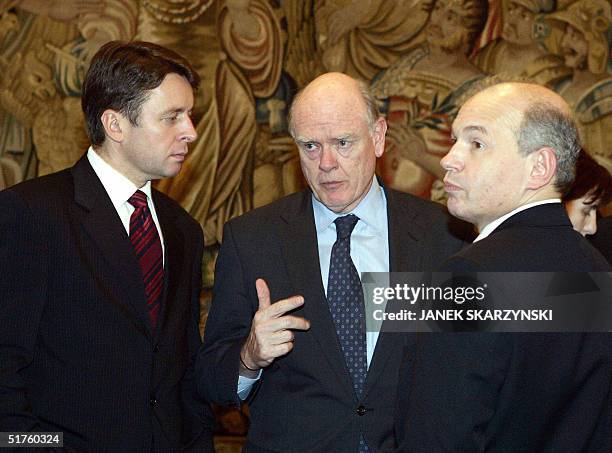 Treasury Secretary John Snow talks with Slovakian Finance Minister Ivan Miklos and his Hungarian counterpart Tibor Draskovics during a meeting of the...