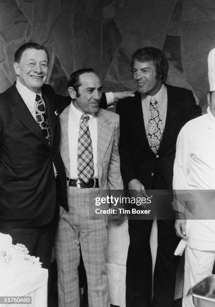 Americans restaurateur Toots Shor , baseball player and manager Yogi Berra and football player and sportscaster Frank Gifford pose together at an...
