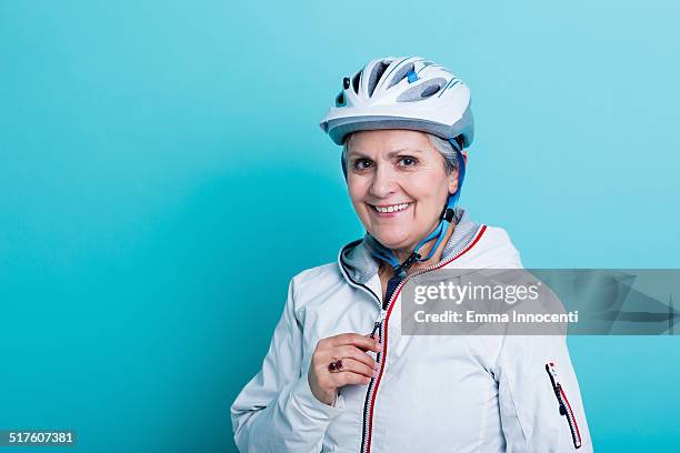 cyclist mature woman with sport clothes - crash helmet stock pictures, royalty-free photos & images