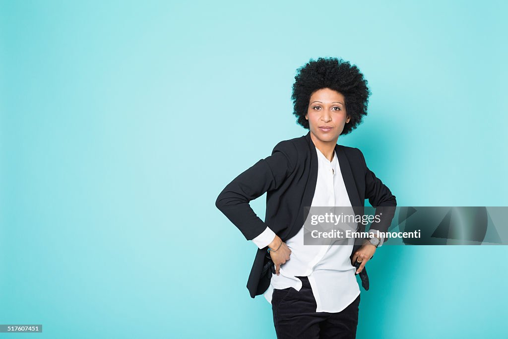 Confident woman with afro, white shirt and jacket