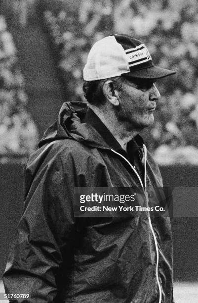 American football coach Paul 'Bear' Bryant watches his team, The University of Alabama Crimson Tide, from the sidelines during a game, circa 1980.