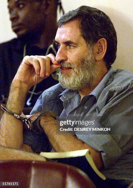 South African Nick du Toit, the chief accused, is pictured handcuffed at Congress Palace in Malabo, 18 November 2004, during a resumption of a trial...