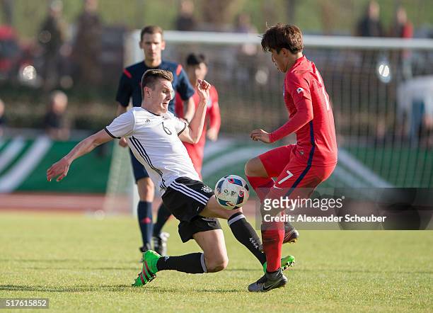Hanbin Park of South Korea challenges Gino Fechner of Germany during the international friendly match between Germany and South Korea on March 26,...