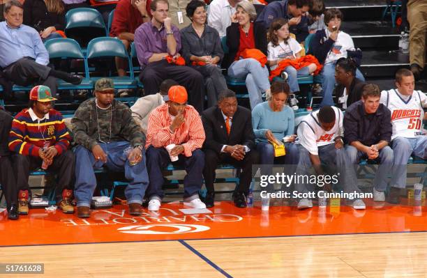 Charlotte Bobcats team owner Robert L. Johnson sits with minority owner Nelly and watches the team play the Washington Wizards November 4, 2004 at...