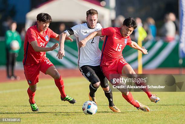 Chiin Jeong of South Korea and Youngwook Cho of South Korea challenges Matthias Bader of Germany during the international friendly match between...