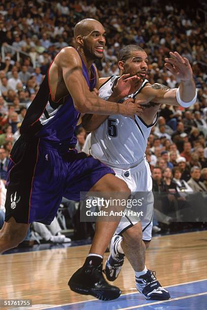 Loren Woods of the Toronto Raptors moves to the basket against Carlos Boozer of the Utah Jazz at Delta Center on November 10, 2004 in Salt Lake City,...