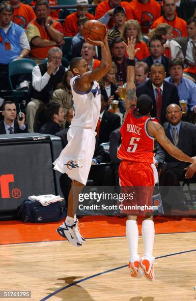Juan Dixon of the Washington Wizards shoots against Eddie House of the Charlotte Bobcats November 4, 2004 at the Charlotte Coliseum in Charlotte,...