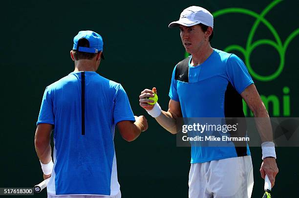 Omar Jasika and John-Patrick Smith of Australia play a match against Nenad Zimonjic of Serbia and Edauard Roger-Vasselin of France during Day 6 of...