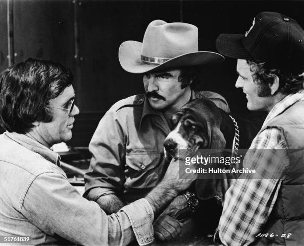 American director Hal Needham lines up a shot with actors Burt Reynolds and Jerry Reed and Happy on the set of the movie 'Smokey and the Bandit,'...
