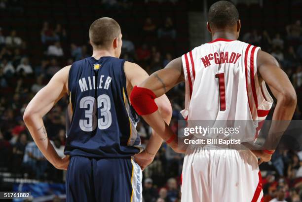 Mike Miller of the Memphis Grizzlies stands next to Tracy McGrady of the Houston Rockets during the game on November 9, 2004 at the Toyota Center in...