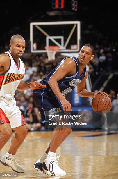 Howard Eisley of the Utah Jazz moves the ball while under pressure from Derek Fisher of the Golden State Warriors during a game at The Arena in...