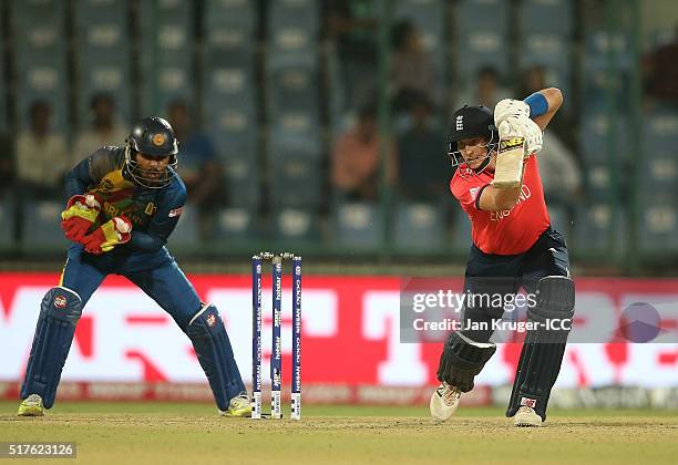 Joe Root of England bats with Dinesh Chandimal of Sri Lanka looking on during the ICC World Twenty20 India 2016 Super 10s Group 1 match between...