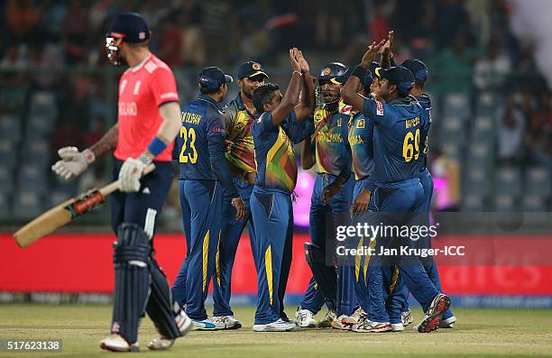 Rangana Herath of Sri Lanka celebrates the wicket of Alex Hales of England during the ICC World Twenty20 India 2016 Super 10s Group 1 match between...