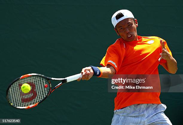 Tatsuma Ito of Japan plays a match against Gael Monfils of France during Day 6 of the Miami Open presented by Itau at Crandon Park Tennis Center on...