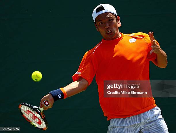 Tatsuma Ito of Japan plays a match against Gael Monfils of France during Day 6 of the Miami Open presented by Itau at Crandon Park Tennis Center on...