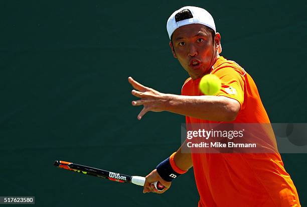 Tatsuma Ito of Japan plays a match against Gael Monfils of France during Day 6 of the Miami Open presented by Itau at Crandon Park Tennis Center on...