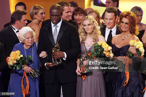 Actor Tom Hanks chats with actress Sibel Kekilli while standing with Heidi Kabel, Seal and Diane Kruger at the conclusion of the Bambi Awards 2004 at...