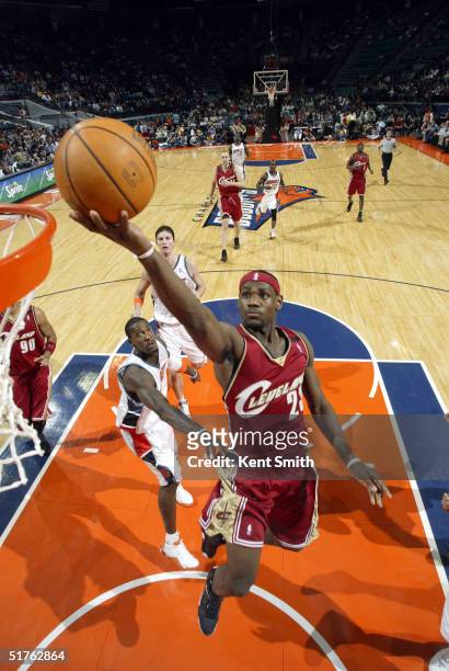 LeBron James of the Cleveland Cavaliers jumps to the basket against Gerald Wallace of the Charlotte Bobcats during the NBA game on November 18, 2004...