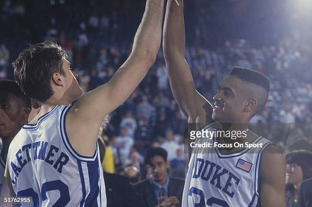 Duke players Grant Hill and Christian Laettner high-five each other in celebration during the NCAA Championship against Kansas in 1991. Duke defeated...