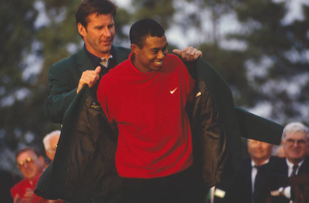 Tiger Woods recieves his Green Jacket for winning the Masters Tournament at the Augusta National Golf Club on April 13, 1997 in Augusta, Georgia....