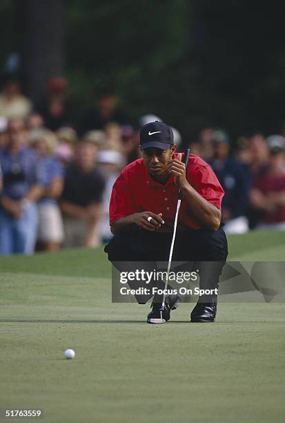 Tiger Woods lines up his putt during the Masters Tournament at the Augusta National Golf Club on April 13, 1997 in Augusta, Georgia. Tiger Woods won...
