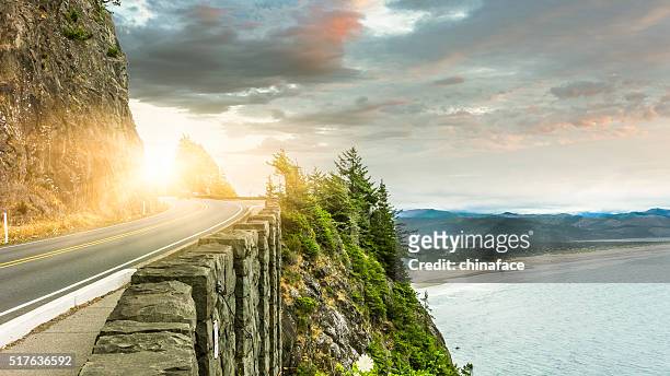 clean winding road through mountain and ocean - washington state road stock pictures, royalty-free photos & images
