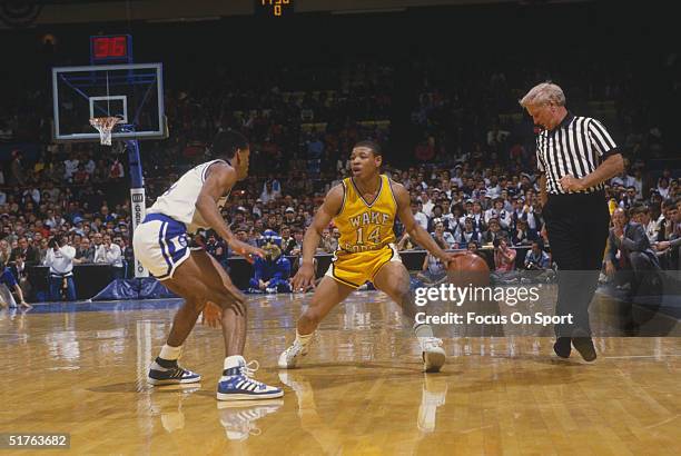 Tyrone "Mugsy" Bogues of Wake Forest College looks to move against a player for Duke University during the 1980s.