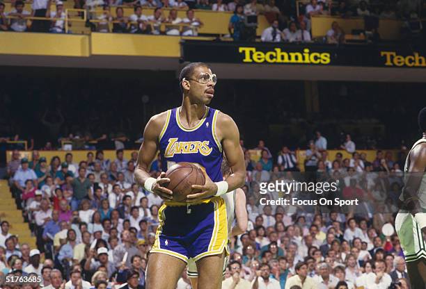 Kareem Abdul-Jabbar of the Los Angeles Lakers looks for a pass against the Boston Celtics during a 1987 NBA game at the Boston Garden in Boston,...