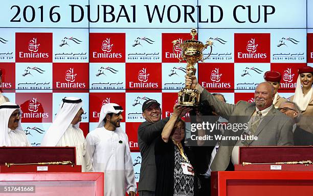 Sheikh Hamdan bin Mohammed bin Rashid Al Maktoum presents the World Cup to the team of California Chrome after winning the Dubai World Cup Sponsored...