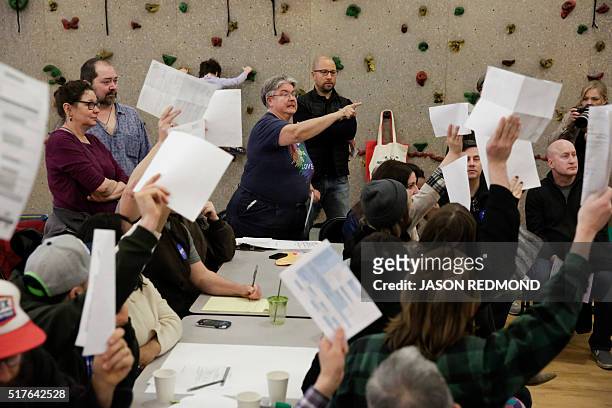 Precinct volunteer Karen Jensen takes a tally of candidate votes during Washington State Democratic Caucuses at Martin Luther King Elementary School...