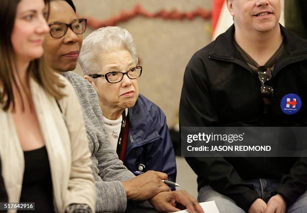 Sonja Cook-Sewart listens as people talk about their candidate choices during Washington State Democratic Caucuses at Martin Luther King Elementary...