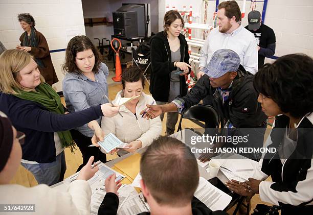 Tally of candidate votes is taken as people participate in Washington State Democratic Caucuses at Martin Luther King Elementary School in Seattle on...