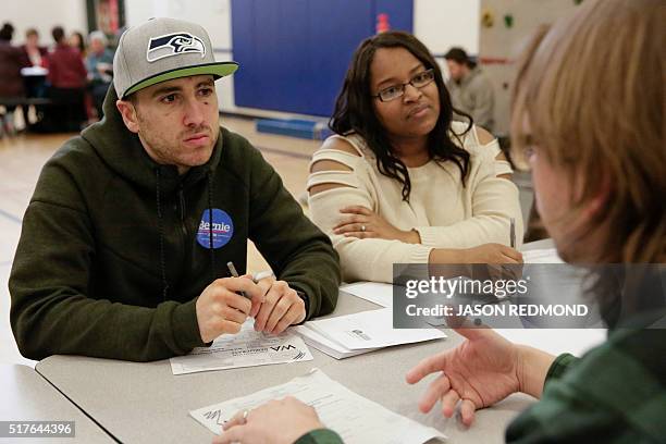 Bernie Sanders supporters Rudy Horn and Gevelle Cullen talk with other voters during Washington State Democratic Caucuses at Martin Luther King...