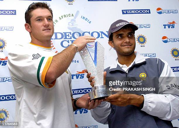 Indian cricket team captain Sourav Ganguly and South African captain Graeme Smith pose with the trophy which will be awarded to the winner of their...