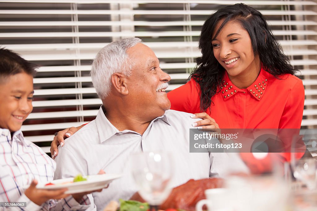 Family, child with grandfather on Thanksgiving day. Dinner table.