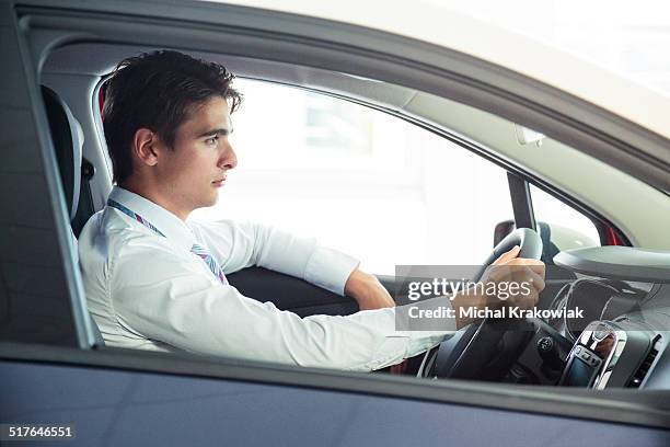 driver in a modern compact car - car white background stockfoto's en -beelden