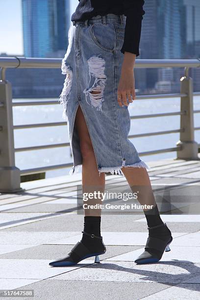 Emily Mercer wearing high waisted ripped One Teaspoon denim skirt, Rag & Bone navy sweater, black and blue Kenzo shoes, black socks by Stance, rings...