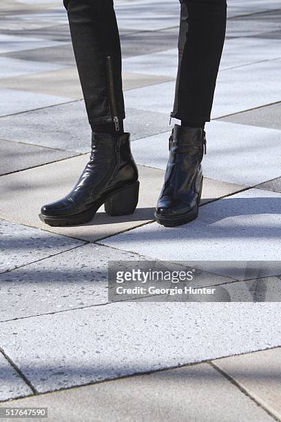 Emily Mercer wearing black BLK DNM pants with zip and Opening Ceremony black patent booties on March 26, 2016 in New York City.