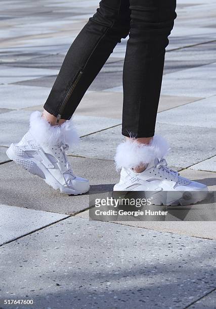 Emily Mercer wearing black BLK DNM pants with zip, white Nike sneakers and white socks with feather top by Rihanna with Stance on March 26, 2016 in...