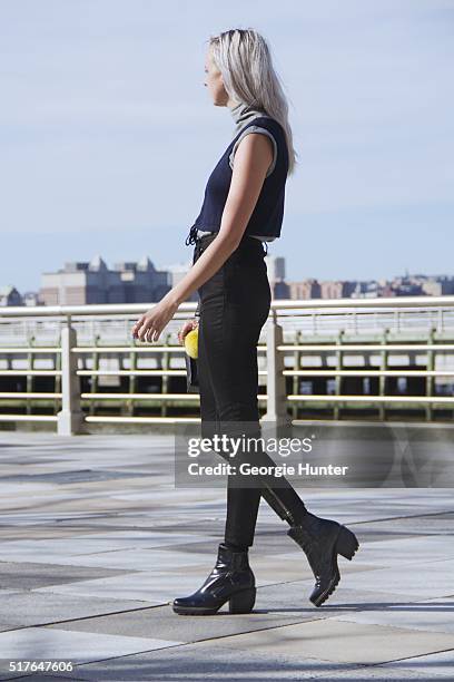 Emily Mercer wearing vintage grey turtleneck sleeveless sweater, blue Urban Outfitters navy top with tie, black high waisted BLK DNM pants, PaPer...