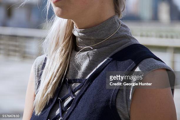 Emily Mercer wearing vintage grey turtleneck sleeveless sweater, blue Urban Outfitters navy top with tie and gold choker necklace on March 26, 2016...